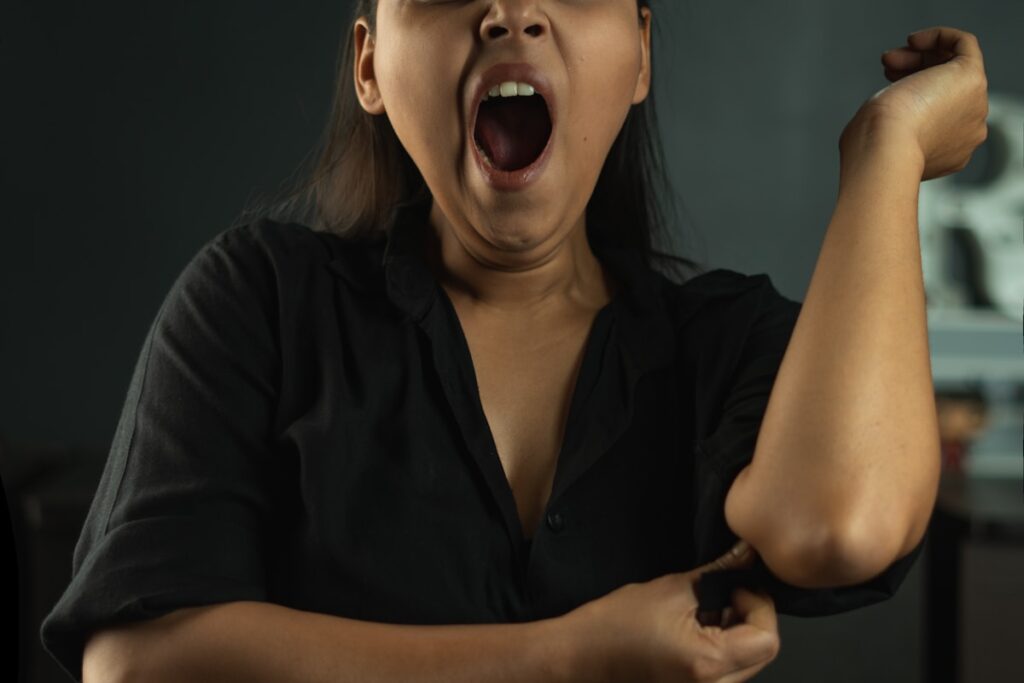woman in black shirt Yawning of tired in a black background image 9 2