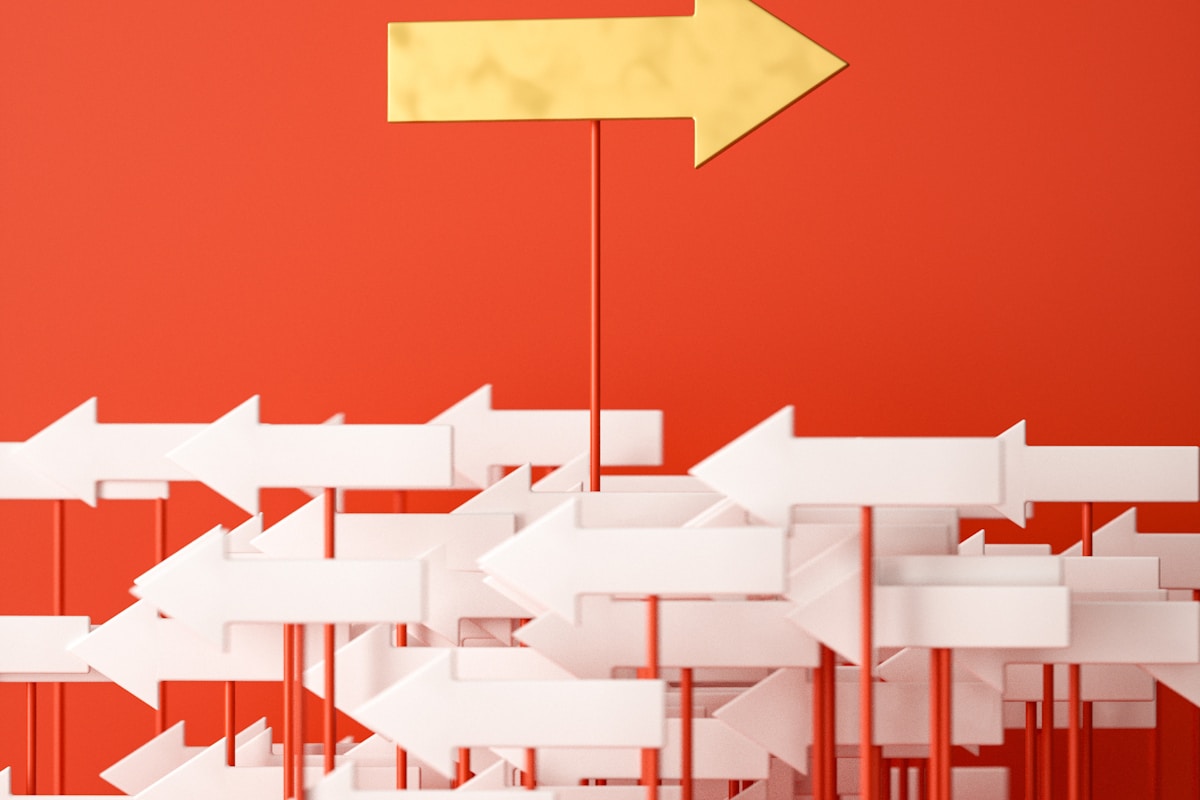 a red wall with a yellow arrow pointing in opposite directions a red wall with a yellow arrow pointing in opposite directions