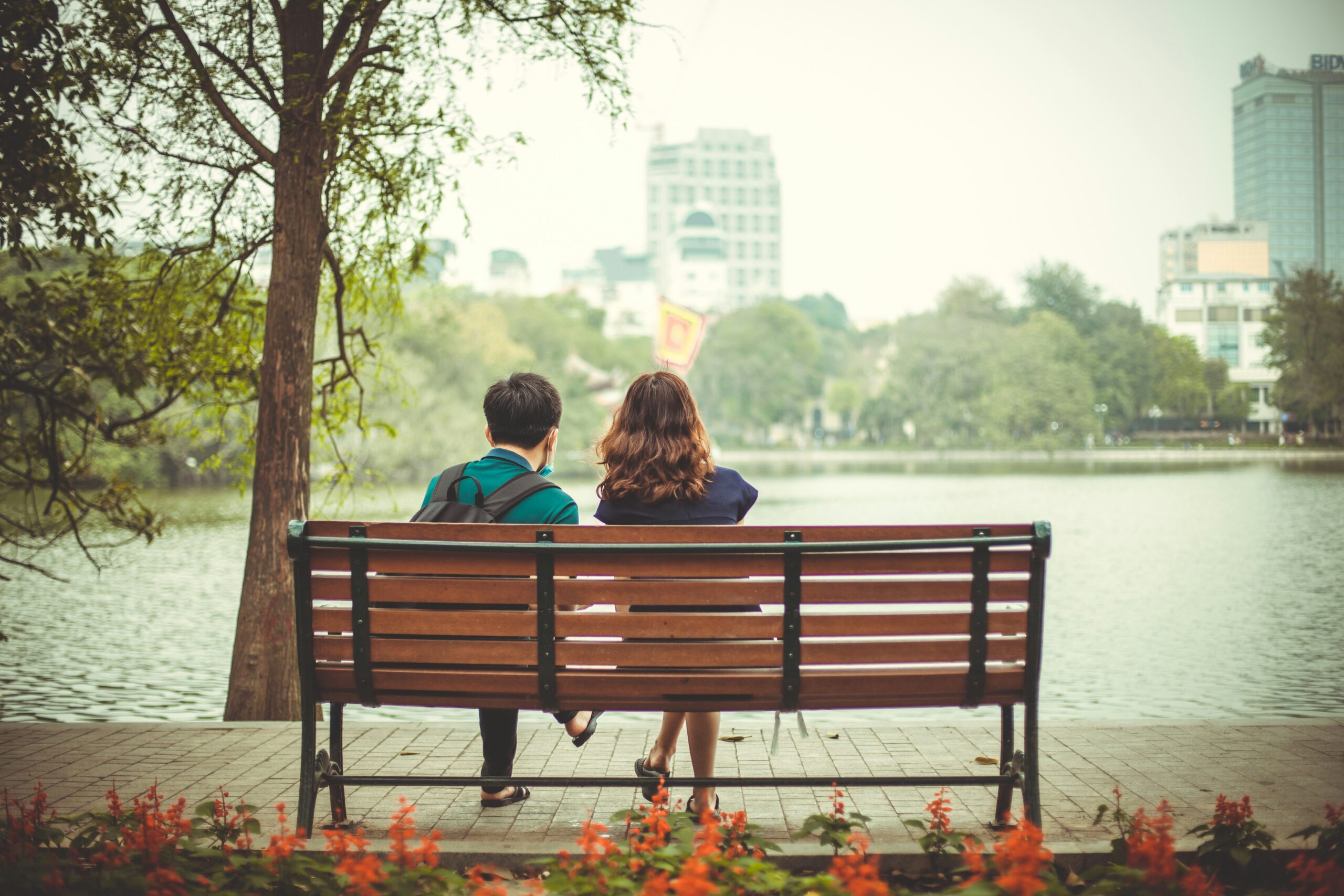 Cómo Detectar Gaslighting en tus Relaciones: Señales Clave 1 Dos mujeres conversando en un banco de madera, reflexionando sobre el gaslighting.